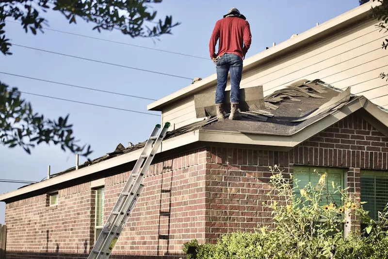 Professional roofer working on a residential roof in Elberon